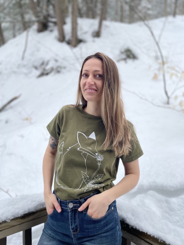 A photo of Caylin Gans of Forest Schooled surrounded by snow